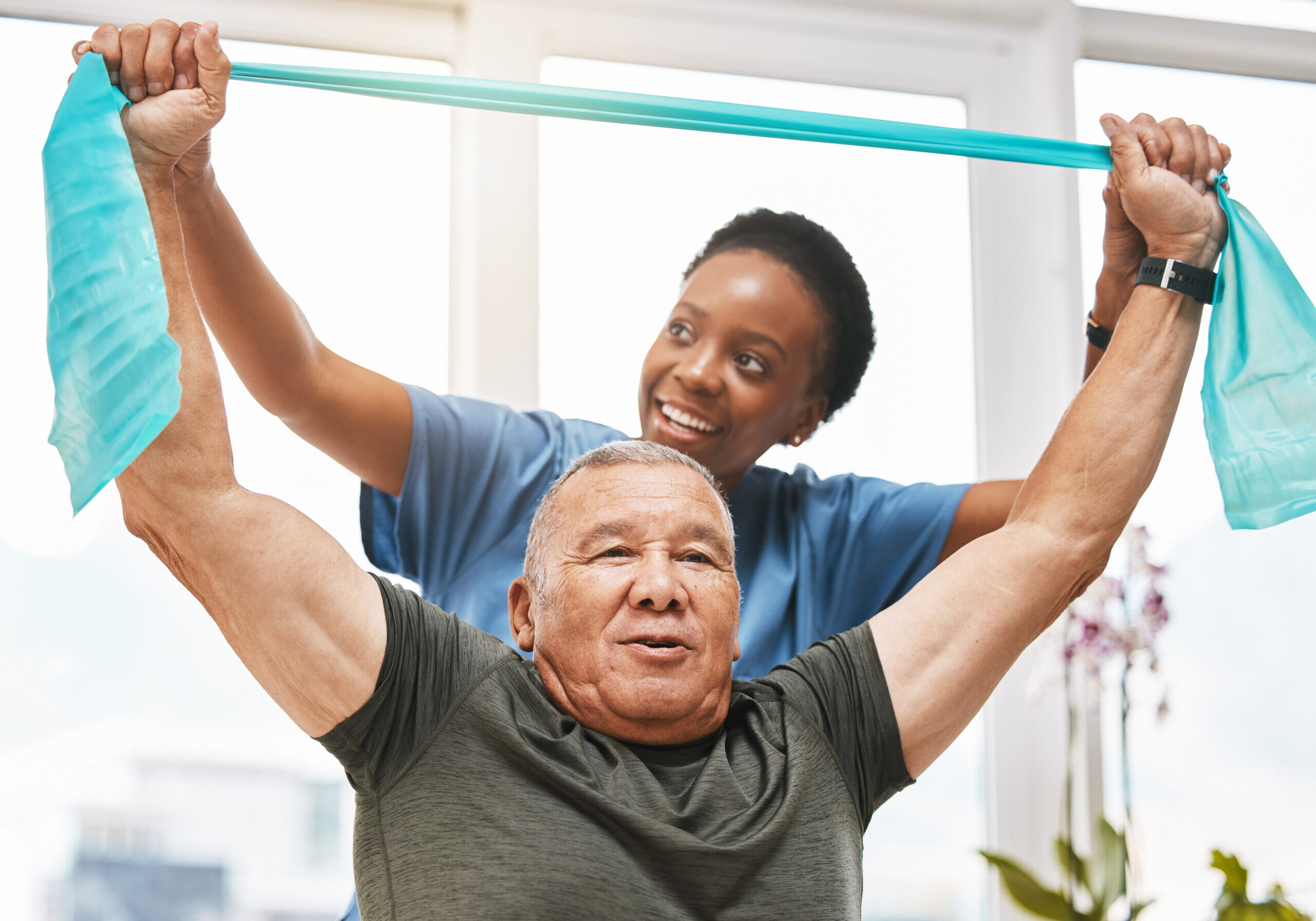 Physiotherapy help, stretching band and doctor with senior man for physical therapy, rehabilitation and healthcare support. Black woman chiropractor or physiotherapy doctor consulting elderly patient
